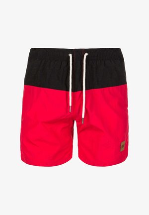 Raudoni ir juodi maudymosi šortai su elastingu juosmeniu, balta raišteliu ir mažos prekės ženklo etiketės šone. Lygi tekstūra, lengvas audinys.