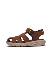 Brun lädersandal med flera remmar, öppen design, dragkedjestängning, upphöjd sula och en diskret logotyp. Har kontrasterande svarta accenter.