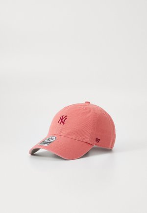 Casquette de baseball en tissu rose avec logo NY brodé, visière incurvée et bandeau ajustable. Présente une étiquette "47" sur le côté.