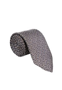 Rullitud siidist lips, millel on geomeetriline muster tumesinisel ja beežil taustal, sujuva tekstuuri ja terava otsaga.