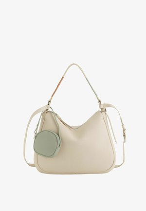 Cream-colored leather handbag with a curved handle wrapped in brown and green, a detachable strap, and a small round green pouch attached.