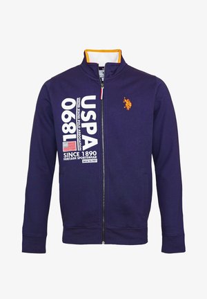 Marineblå sportsjakke med lynlås, orange logo, gult kravefor, og hvid USPA-tekst samt amerikansk flag på venstre forside.