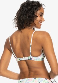 Bikini top s kvetinovým vzorom v pastelových farbách, s nastaviteľnými popruhmi a háčkovým zapínaním na zadnej strane. Hladká textúra látky.