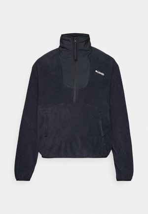 Pull en polaire bleu marine avec un col haut, un zip frontal demi-long, deux poches latérales zippées et une texture lisse. Logo Columbia sur la poitrine.