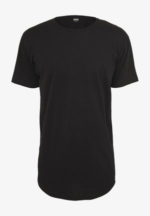 T-shirt noir à manches courtes en coton. Présente un col rond et une coupe droite avec un ourlet arrière légèrement plus long. Texture douce.