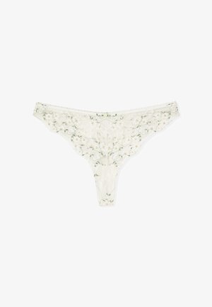 String blanc en dentelle avec broderie florale aux tons verts et orange clair, orné d'un petit noeud décoratif central.