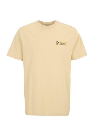 Beige cotton t-shirt with short sleeves, featuring a small graphic design and text on the left chest area. Classic crew neck style.