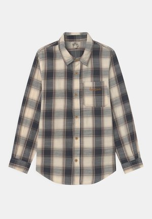 Koszula z długim rękawem w kratę w odcieniach niebieskiego, kremowego i brązowego. Wykonana z miękkiego materiału, z kieszonką na piersi i złotym haftem.