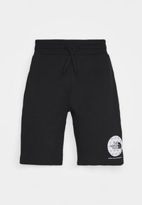 Černé bavlněné šortky s elastickým pasem a šňůrkou na stažení. Na levé noze mají bílé logo s geometrickým vzorem.