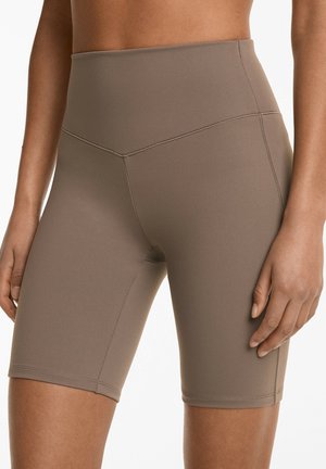 Pantaloni scurți de bicicletă cu talie înaltă, într-o nuanță de taupe, realizați dintr-un material neted și elastic, cu cusături plate și un design ajustat.