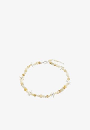 Náhrdelník s malými béžovými korálkami, ktoré sa striedajú so striebornými príveskami v tvare morskej hviezdice a so strieborným zapínaním na bielom pozadí.