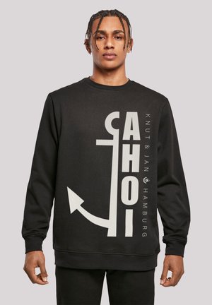 Black sweatshirt featuring a large white anchor graphic and text "AHOI" and "Knut & Jan Hamburg." Smooth fabric, crew neck, long sleeves.