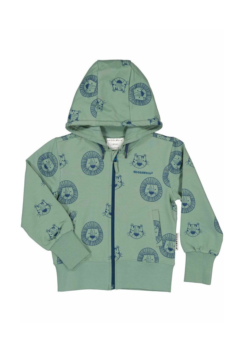 Grön zip-up hoodie med huva, som har mönster av en mörkblå lejon och ansikten. Tillverkad av mjukt tyg, med ribbade ärmmuddar och en ficka.