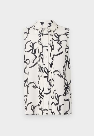 Ermeløs bluse i hvidt stof med sort båndmønster. Har knaplukning, krave og plisserede detaljer foran.