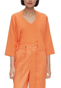 Orange, lightweight knit cardigan with three-quarter sleeves, open front, paired with matching orange cropped trousers featuring drawstring waist.