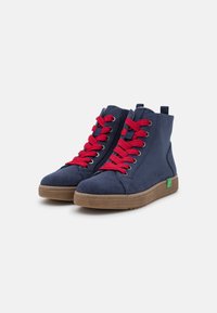 Navy suede high-top shoes with red laces, textured rubber sole, green accent on the side, and loop at the back for easy wear.