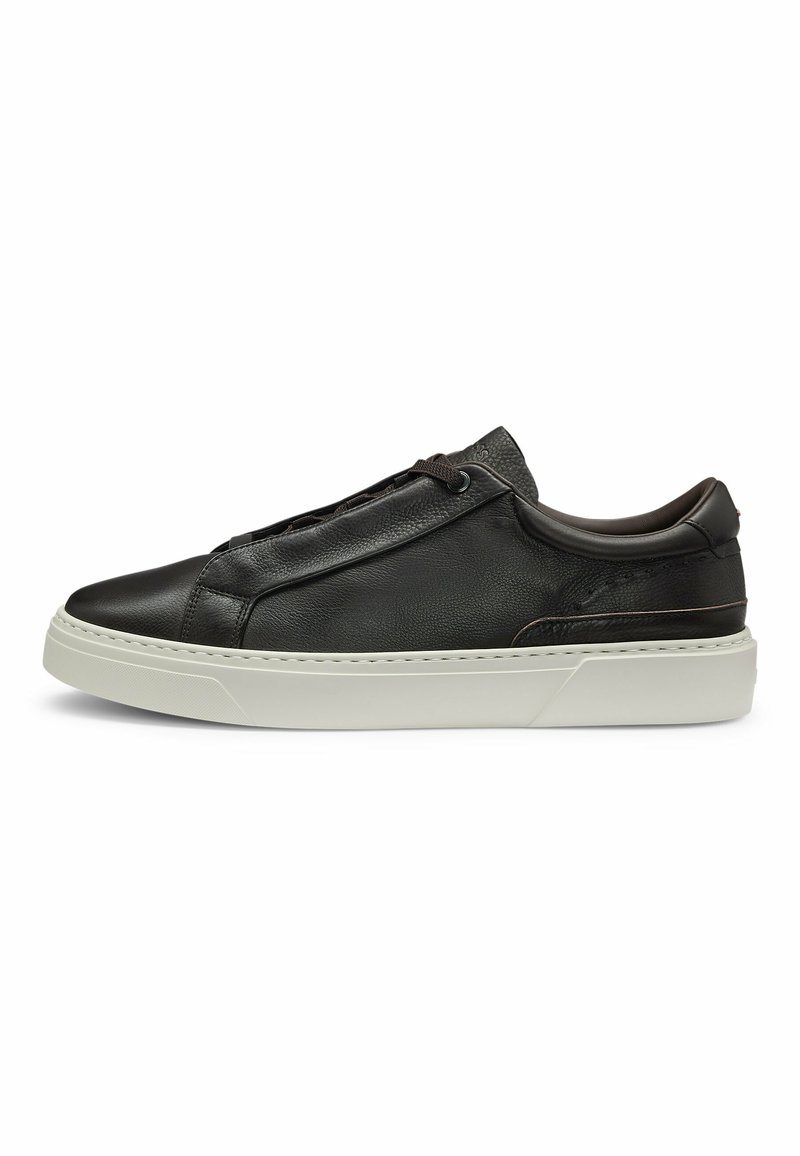 Black leather sneaker with a minimalist design, elastic laces, and a textured finish. Features a white rubber sole and subtle stitching details.