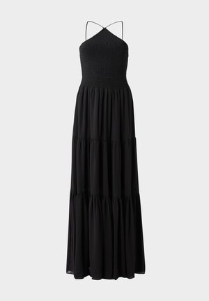 Fekete maxi ruha rugalmas mellekzettel, vékony, állítható pántokkal és réteges szoknyával. Simább anyagminőség, folyékony sziluett.