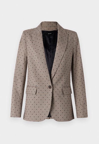Beige blazer med tjekmønster og små sorte prikker, to forlommer, enkelt knaplukning og en sort quiltet foring indeni.
