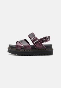Platform sandals with shiny black and purple faux leather, featuring cross straps, adjustable buckles, and a chunky black sole with textured tread.