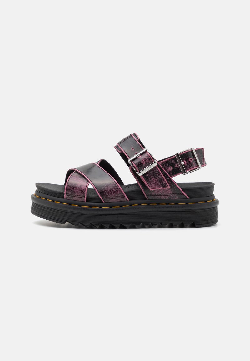 Platform sandals with shiny black and purple faux leather, featuring cross straps, adjustable buckles, and a chunky black sole with textured tread.