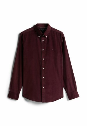 Burgunderfarbener Cordhemd mit langen Ärmeln, Button-Down-Kragen und weißen Knöpfen. Mit einem kleinen Logo auf der linken Brust.