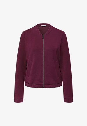 Giacca bomber bordeaux con zip frontale, polsini e orlo a coste. Presenta due tasche laterali e una texture di tessuto liscia.