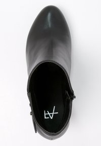 Black leather ankle boot with a pointed toe, smooth texture, and subtle branding inside. Side zipper detail for easy wear.