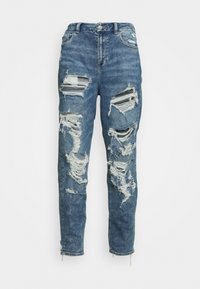 Högmidjade blå denimjeans med rivna knän och fransiga kanter. Har en knappstängning och design med fem fickor. Sliten textur genom hela byxan.
