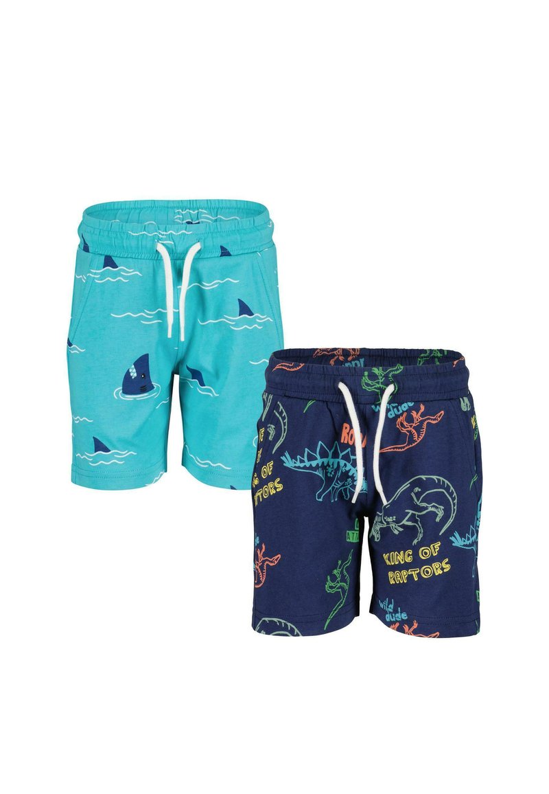 Deux paires de shorts : l'une turquoise avec des imprimés de requins et de vagues, l'autre marine avec des motifs de dinosaures. Les deux ont des ceintures élastiques et des cordons de serrage.