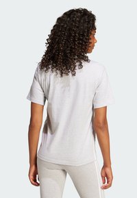Gray short-sleeve t-shirt with a relaxed fit, featuring a smooth texture and a rounded hem, viewed from the back.