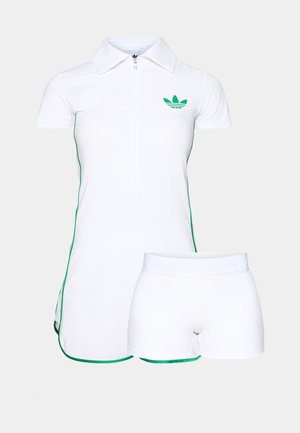 White athletic dress with a front zipper, short sleeves, green accents along the seams, and matching white shorts, made of smooth fabric.