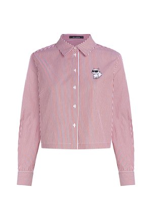Cropped shirt in red and white vertical stripes, cotton fabric, featuring a collar, button closure, and a cartoon raccoon graphic on the chest.