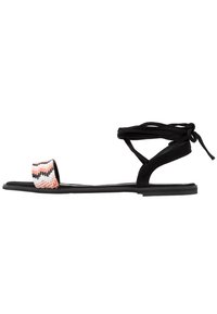 Flat sandal with a black suede design, featuring a beaded strap in pink, white, and black zigzag pattern. Ankle ties complete the look.