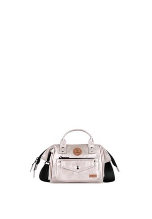 Small metallic silver handbag with dual top handles, front zip and snap pockets, black side straps, and a round brown logo patch.
