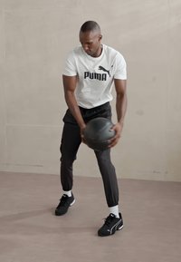 Puma FLEX CARGO PANT - Pantalon de survêtement - black