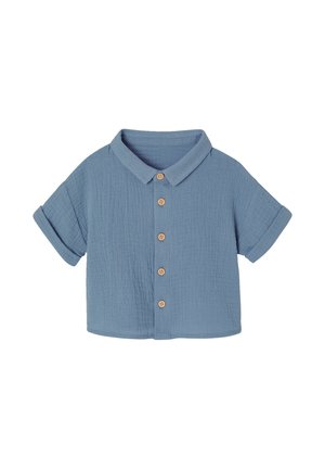 Short-sleeve blue toddler shirt with wooden buttons, a pointed collar, and rolled cuffs on a white background.