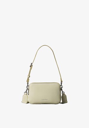 Sac bandoulière rectangulaire en cuir couleur crème avec bandoulière réglable et ferrures argentées, logo Calvin Klein embossé au centre à l'avant.