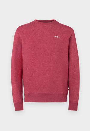 Punainen collegepaita, joka on valmistettu tekstuurikankaasta. Siinä on pyöreä kaula-aukko sekä resorit hihansuissa ja helmassa. Rinnassa pieni valkoinen logo.