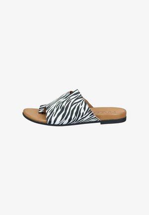 Flat slide sandal with black and white zebra print upper and tan footbed with open toe and toe loop.