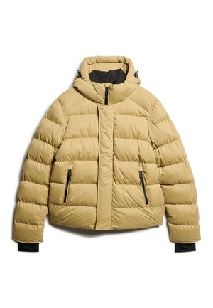 Chaqueta tipo abrigo en color beige claro, con cuello alto, cierre con cremallera en la parte delantera y dos bolsillos laterales. Fabricada con un tejido acolchado de textura suave.