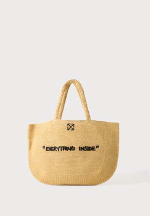 Beige woven tote bag with two handles and the phrase "EVERYTHING INSIDE" stitched in black on the front.