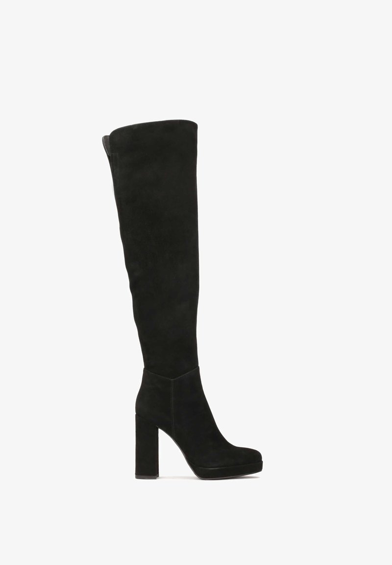 Black over-the-knee boots made of suede with a block heel, rounded toe, and a smooth texture. Seam detailing at the ankle.