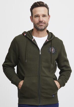 Olive green zip-up hoodie with a lined hood, logo print, front pockets, and ribbed cuffs; made from soft, comfortable fabric.
