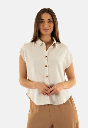Chemise en lin beige clair à boutons, manches courtes, ourlet arrondi, avec des boutons dorés à l'avant pour le détail.