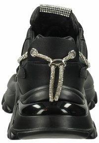 Black athletic shoes with a textured upper, feature sparkling rhinestone accents, elastic laces, and a chunky, cushioned sole.