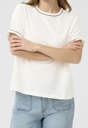 White short-sleeve t-shirt with a black trimmed neckline and sleeves, featuring a relaxed fit and smooth cotton texture. Worn with blue jeans.