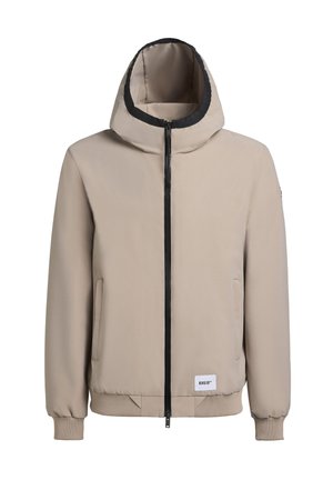 Beige hoodad jacka med en krage som är kantad i svart, framdragkedja och sidofickor. Har ribbade ärmslut och en logotyp på den nedre fållen.