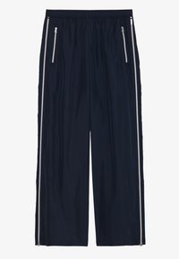 Pantalons de sport bleu marine en tissu léger, dotés d'une coupe large, d'une taille élastique et de poches zippées avec des accents argentés.