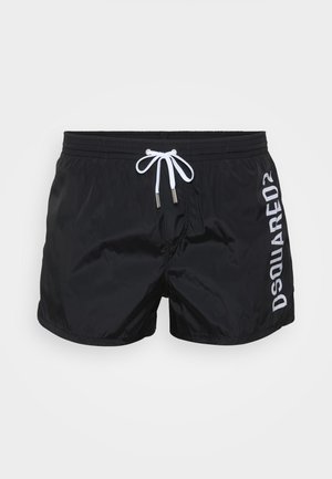 Shorts de bain noirs en matériau léger, avec un cordon de serrage blanc et "DSQUARED2" imprimé sur le côté en blanc.